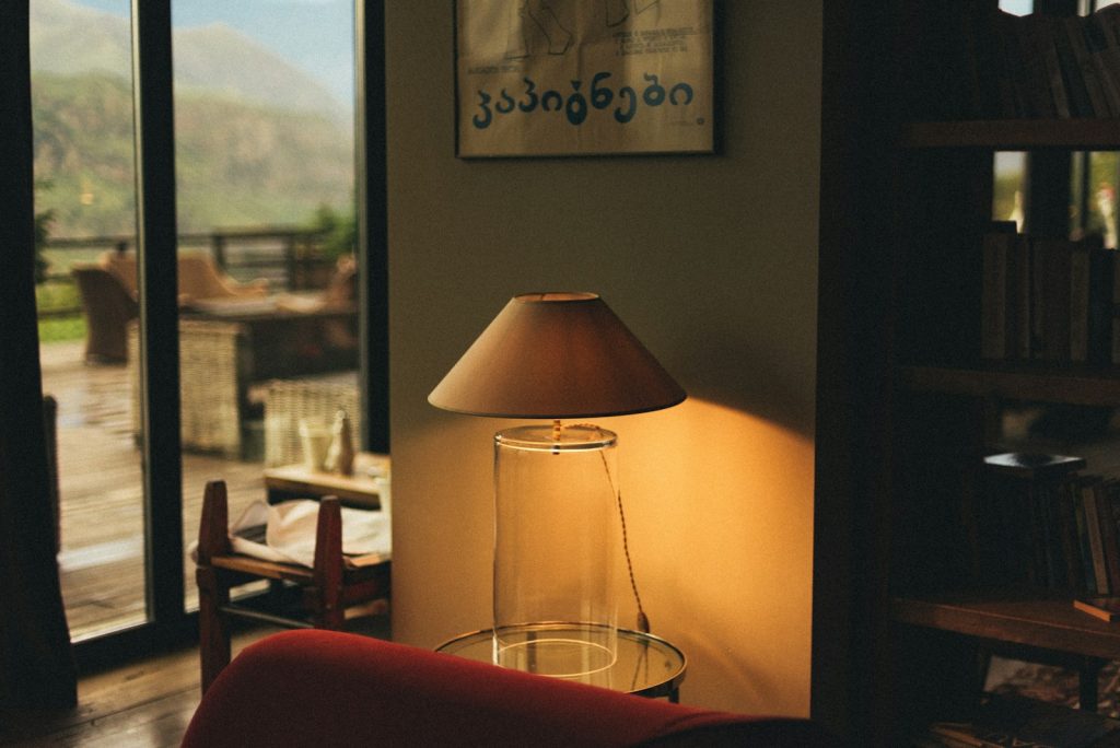 Cozy lamp glows near an open window.